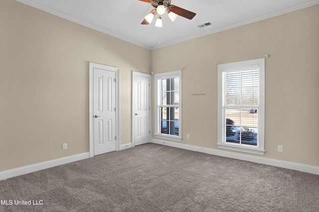 spare room with ceiling fan, carpet, and ornamental molding