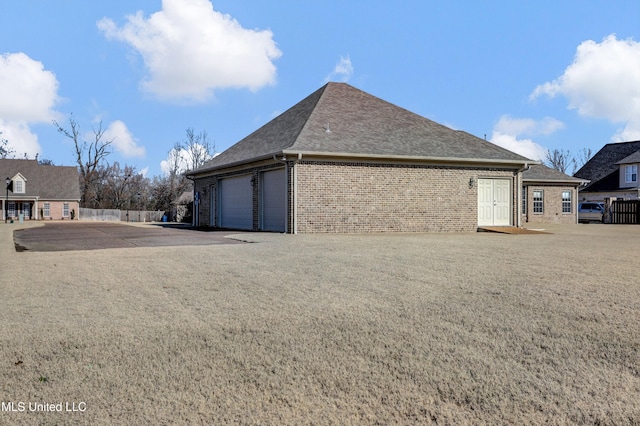 view of side of home with a garage