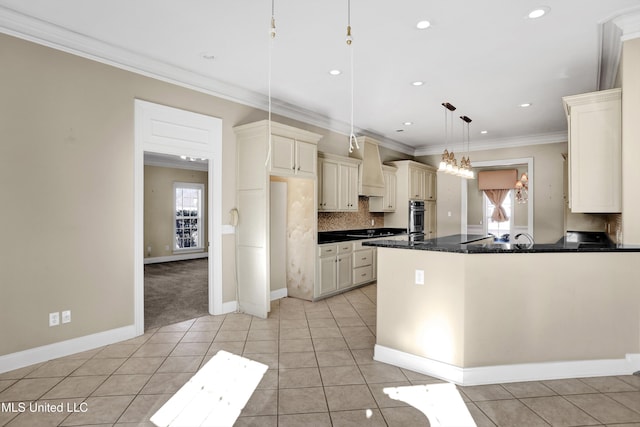 kitchen featuring decorative backsplash, hanging light fixtures, ornamental molding, cream cabinets, and light tile patterned floors