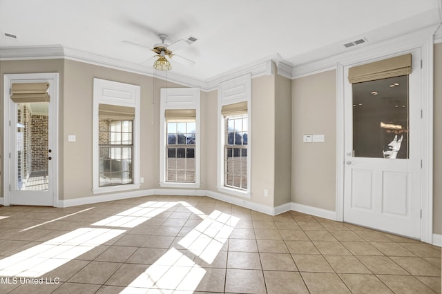 tiled foyer featuring ceiling fan and crown molding