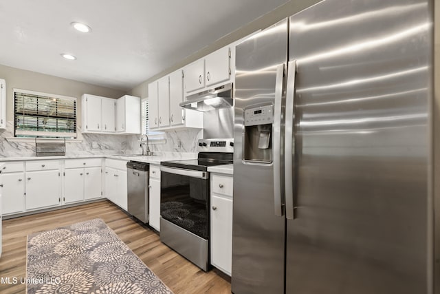 3241 Kings Bridge Rd, Moss Point, MS 39562 - kitchen featuring appliances with stainless steel finishes, under cabinet range hood, light countertops, a sink, and backsplash