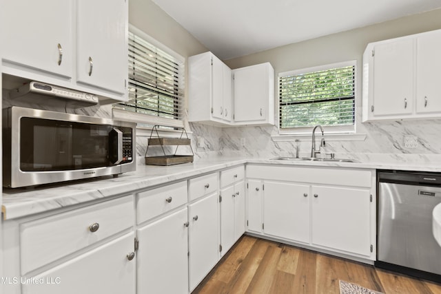 3241 Kings Bridge Rd, Moss Point, MS 39562 - kitchen with stainless steel appliances, a sink, and white cabinetry