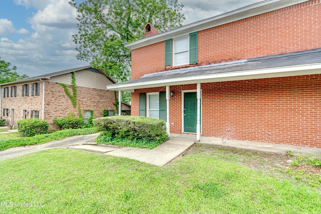 735 Wicklow Pl Unit A, Ridgeland, MS 39157 - view of front of home featuring a front lawn, brick siding, and a chimney