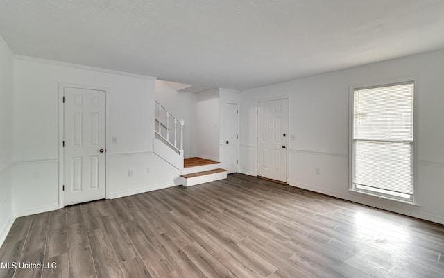 735 Wicklow Pl Unit A, Ridgeland, MS 39157 - unfurnished living room with wood finished floors, stairs, and baseboards