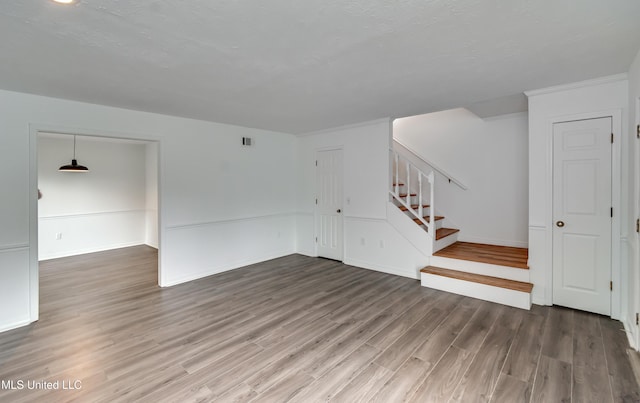 735 Wicklow Pl Unit A, Ridgeland, MS 39157 - unfurnished living room featuring wood finished floors, stairs, and baseboards