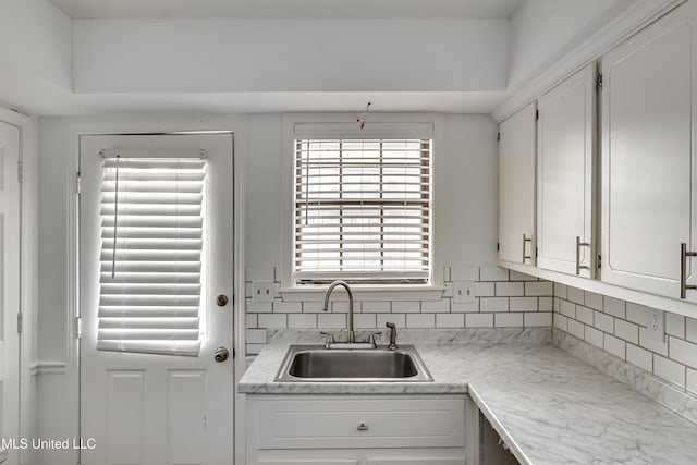 735 Wicklow Pl Unit A, Ridgeland, MS 39157 - kitchen with a sink, white cabinets, decorative backsplash, and light countertops