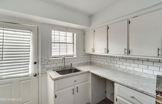 735 Wicklow Pl Unit A, Ridgeland, MS 39157 - kitchen with a sink, white cabinets, tasteful backsplash, and light countertops