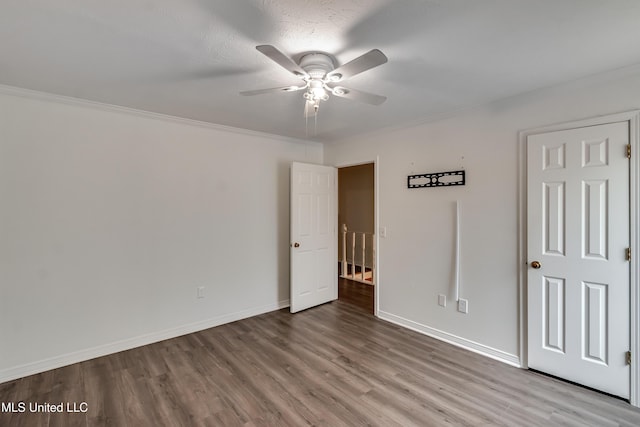 735 Wicklow Pl Unit A, Ridgeland, MS 39157 - unfurnished bedroom featuring wood finished floors, crown molding, baseboards, and ceiling fan