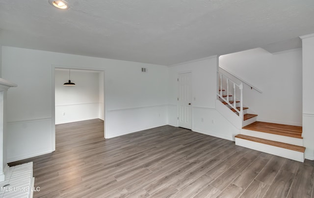 735 Wicklow Pl Unit A, Ridgeland, MS 39157 - unfurnished living room featuring wood finished floors, stairway, and baseboards
