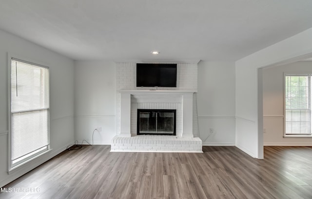 735 Wicklow Pl Unit A, Ridgeland, MS 39157 - unfurnished living room featuring a brick fireplace, wood finished floors, and baseboards