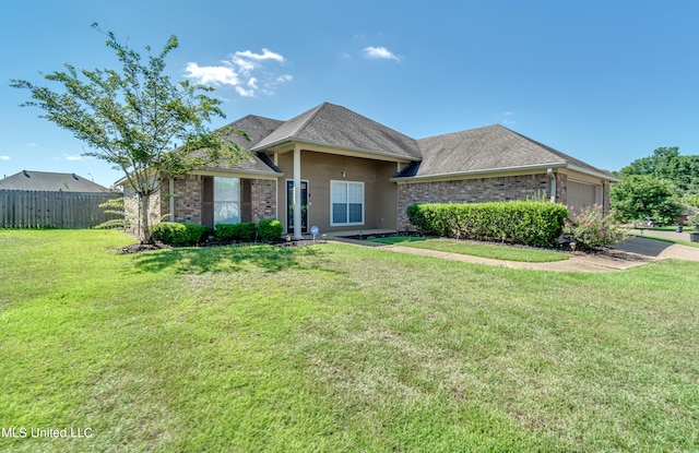 single story home featuring a front lawn