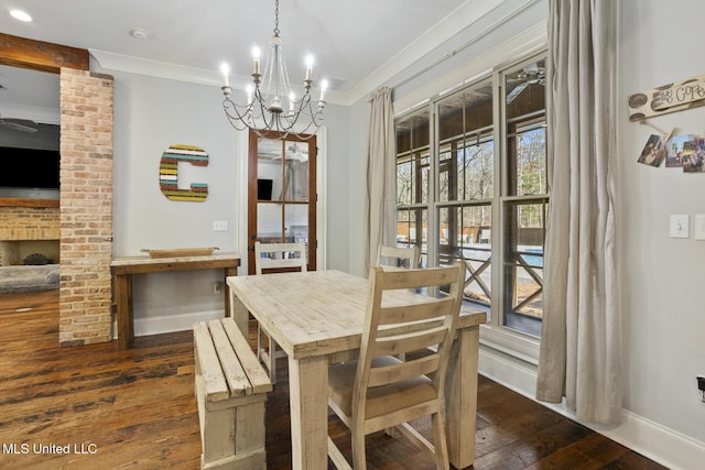 dining room with crown molding, dark hardwood / wood-style floors, and a chandelier