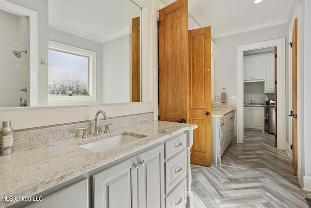 bathroom featuring ornamental molding, parquet flooring, vanity, and walk in shower