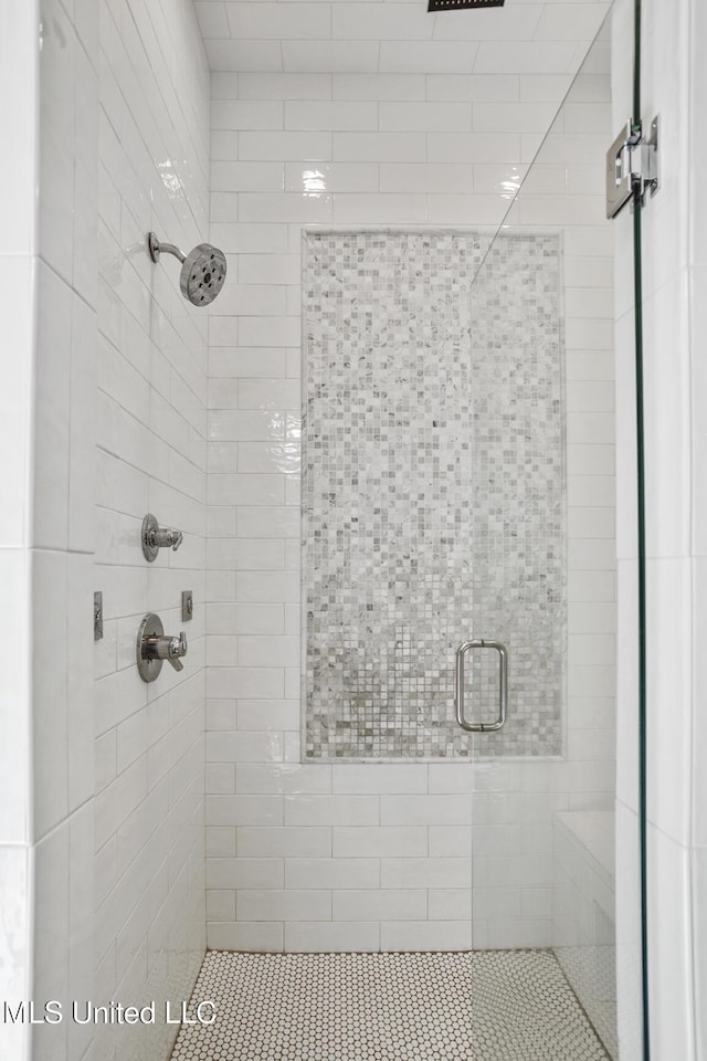 bathroom featuring a shower with shower door