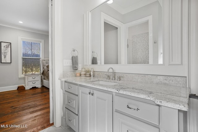 bathroom with vanity, wood-type flooring, ornamental molding, and walk in shower