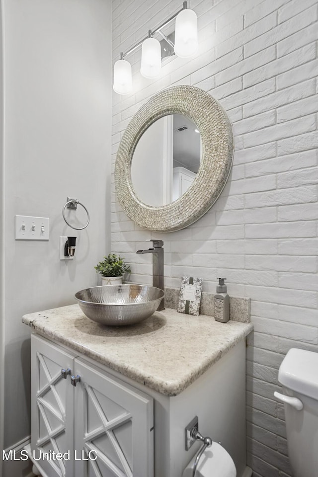 bathroom with vanity and toilet