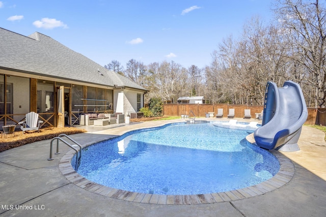 view of pool featuring a water slide and a patio