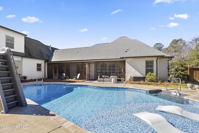 view of pool featuring a sunroom and a patio