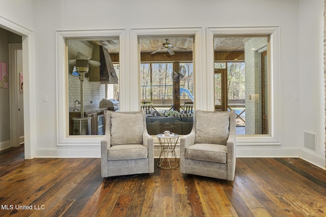 living area with dark hardwood / wood-style floors and sink