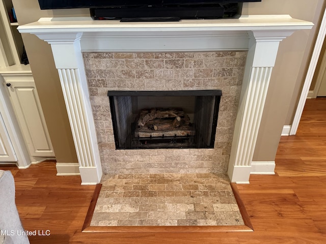 104 Belle Oak Dr, Brandon, MS 39042 - detailed view of baseboards, wood finished floors, and a fireplace