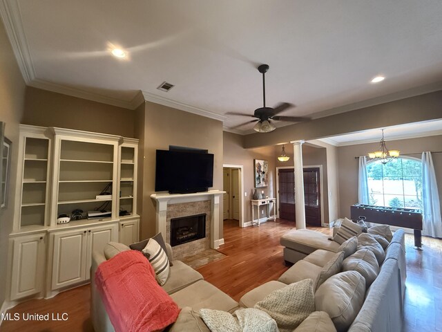 104 Belle Oak Dr, Brandon, MS 39042 - living area featuring ornamental molding, wood finished floors, a ceiling fan, a fireplace, and decorative columns