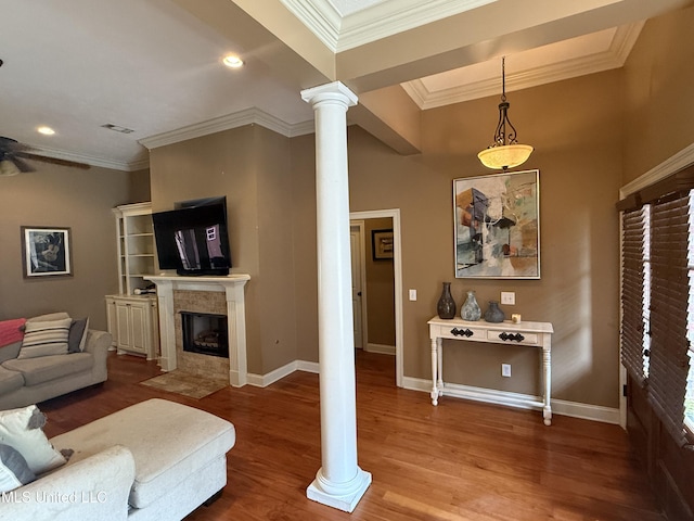 104 Belle Oak Dr, Brandon, MS 39042 - living room featuring decorative columns, wood finished floors, a tile fireplace, baseboards, and a ceiling fan