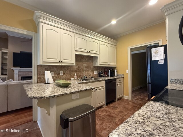 104 Belle Oak Dr, Brandon, MS 39042 - kitchen with dishwasher, a sink, a peninsula, dark tile patterned flooring, and crown molding