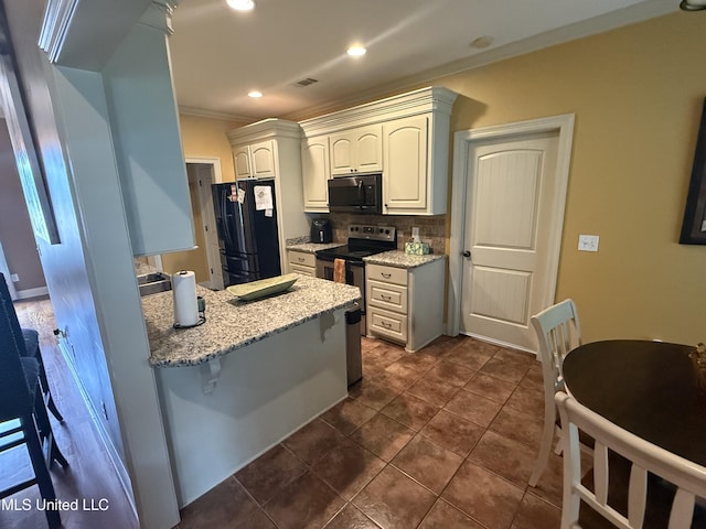 104 Belle Oak Dr, Brandon, MS 39042 - kitchen with black appliances, ornamental molding, backsplash, light stone counters, and a breakfast bar