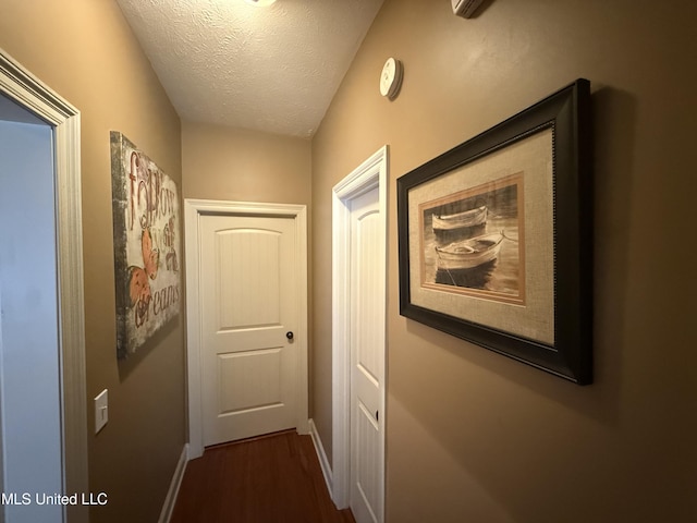 104 Belle Oak Dr, Brandon, MS 39042 - hall featuring dark wood-style floors, a textured ceiling, and baseboards