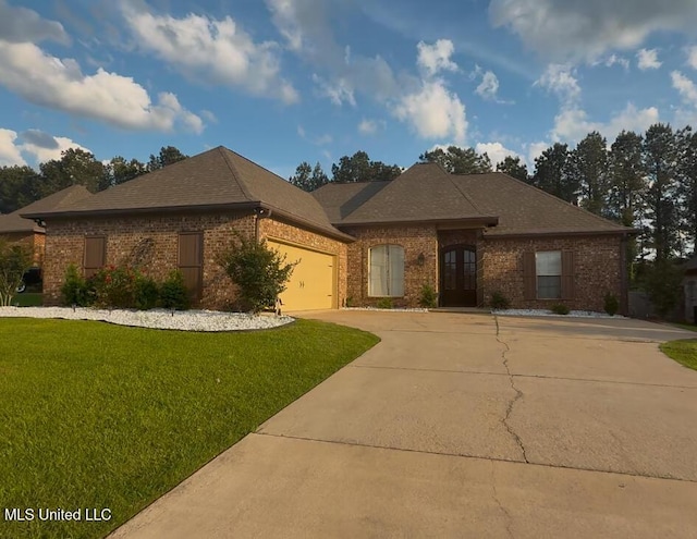 128 Charlton Dr, Madison, MS 39110 - view of front of house featuring brick siding, driveway, an attached garage, a front lawn, and roof with shingles