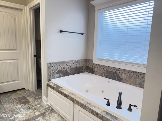 128 Charlton Dr, Madison, MS 39110 - bathroom featuring a tub with jets and toilet