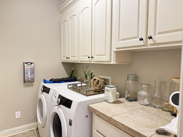 128 Charlton Dr, Madison, MS 39110 - washroom with cabinet space, washer and dryer, baseboards, and tile patterned floors