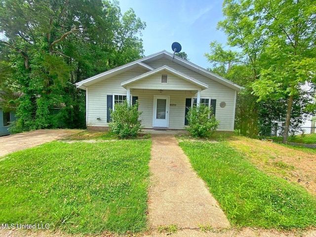 bungalow with a porch and a front lawn