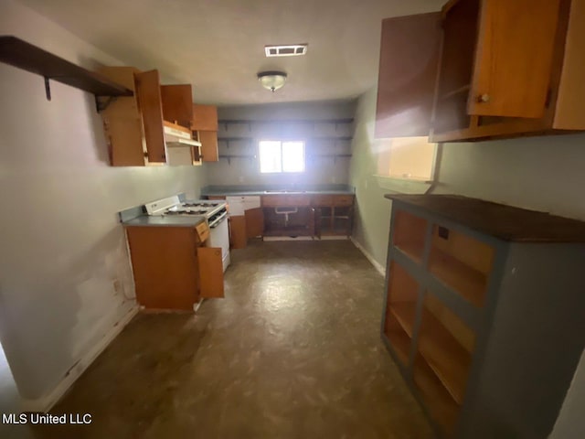 kitchen featuring open shelves, under cabinet range hood, white range with gas stovetop, and visible vents