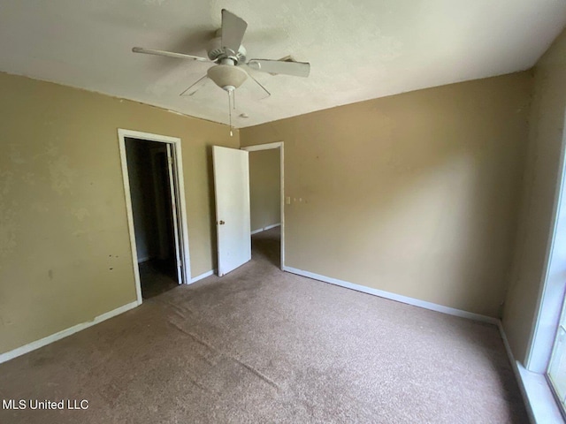 unfurnished bedroom with ceiling fan, baseboards, and carpet
