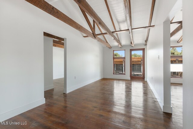 301 S Toulme St Unit 201, Bay Saint Louis, MS 39520 - unfurnished living room with lofted ceiling with beams and dark wood-type flooring