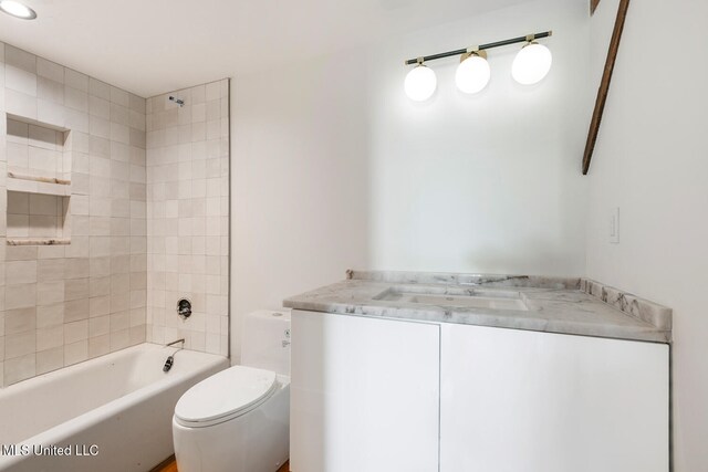 301 S Toulme St Unit 201, Bay Saint Louis, MS 39520 - full bathroom featuring vanity, tiled shower / bath combo, and toilet