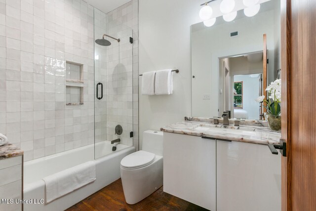 301 S Toulme St Unit 201, Bay Saint Louis, MS 39520 - full bathroom with wood-type flooring, vanity, toilet, and tiled shower / bath