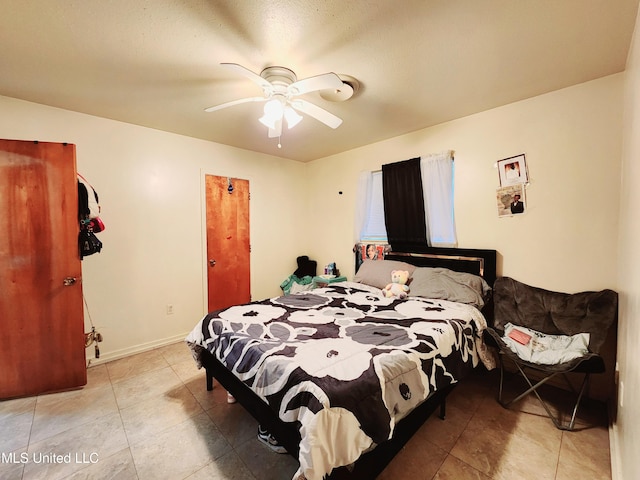 bedroom featuring ceiling fan and light tile patterned floors