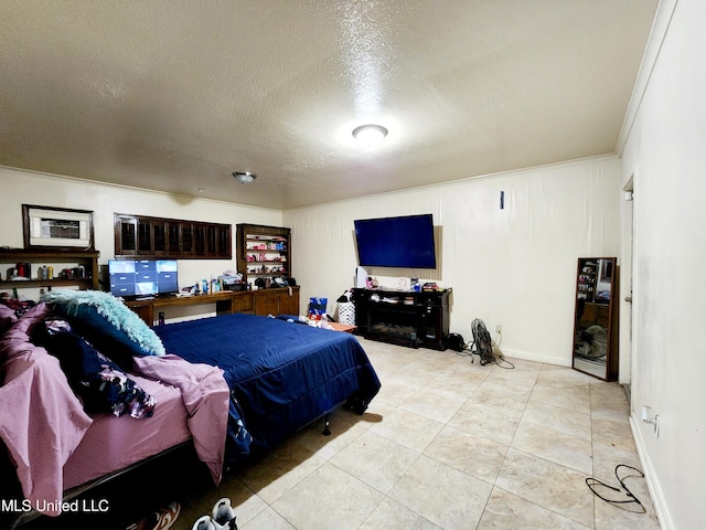 bedroom featuring light tile patterned floors, a textured ceiling, and crown molding