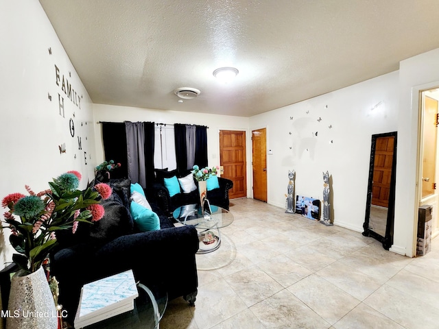 living room with light tile patterned floors and a textured ceiling