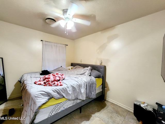 bedroom with light tile patterned floors and ceiling fan