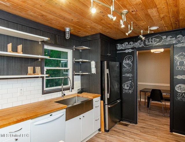 1777 Brecon Dr, Jackson, MS 39211 - kitchen featuring freestanding refrigerator, dishwasher, open shelves, butcher block counters, and a sink