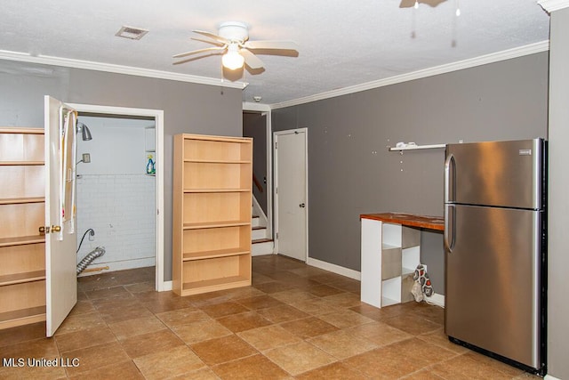 1777 Brecon Dr, Jackson, MS 39211 - kitchen with freestanding refrigerator, ceiling fan, crown molding, and baseboards
