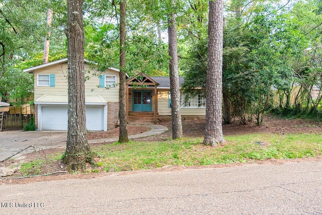 1777 Brecon Dr, Jackson, MS 39211 - split level home with an attached garage and concrete driveway