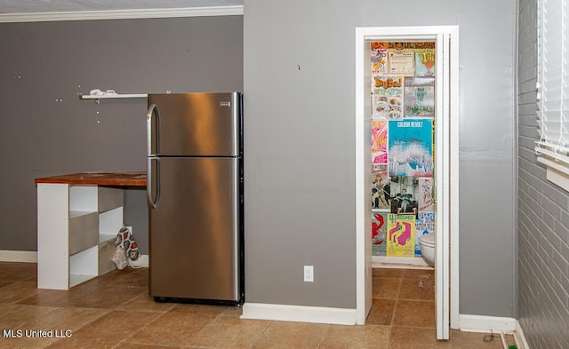 1777 Brecon Dr, Jackson, MS 39211 - kitchen featuring freestanding refrigerator, tile patterned floors, and baseboards