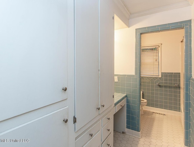 1777 Brecon Dr, Jackson, MS 39211 - bathroom featuring ornamental molding, tile walls, tile patterned flooring, toilet, and vanity