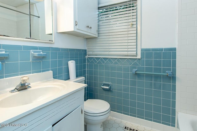 1777 Brecon Dr, Jackson, MS 39211 - bathroom with tile walls, tile patterned floors, toilet, vanity, and a shower
