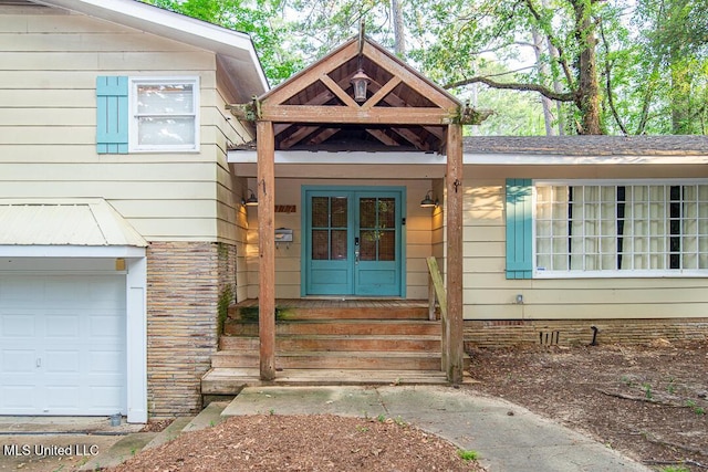 1777 Brecon Dr, Jackson, MS 39211 - view of exterior entry with an attached garage and french doors