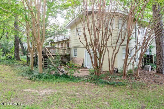 1777 Brecon Dr, Jackson, MS 39211 - back of house featuring a wooden deck, central AC unit, brick siding, and stairway